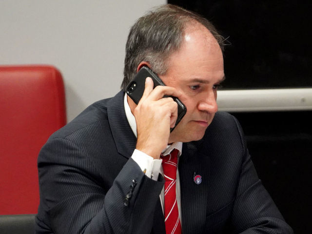 KANATA, ON - OCTOBER 06: General manager Pierre Dorion of the Ottawa Senators sits at the draft table during the first round of the 2020 NHL Entry Draft at Canadian Tire Centre on October 06, 2020 in Kanata, Ontario, Canada. The 2020 NHL Draft was held virtually due to the ongoing Coronavirus pandemic.