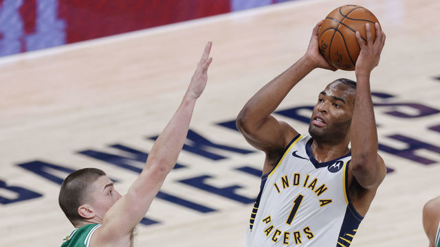 INDIANAPOLIS, IN - DECEMBER 29: T.J. Warren #1 of the Indiana Pacers shoots the ball against Payton Pritchard #11 of the Boston Celtics during the second half at Bankers Life Fieldhouse on December 29, 2020 in Indianapolis, Indiana.