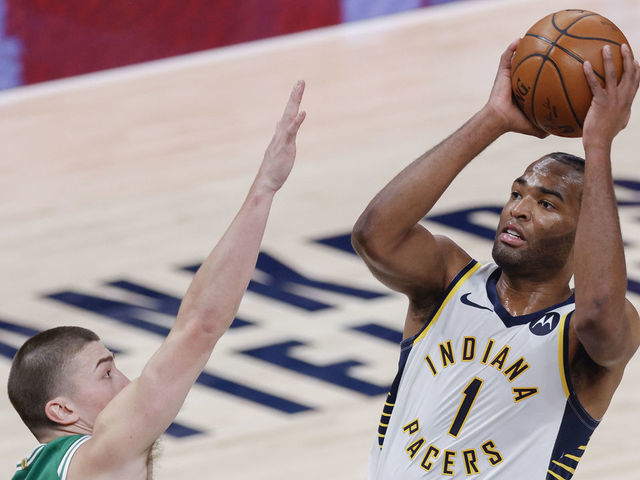 INDIANAPOLIS, IN - DECEMBER 29: T.J. Warren #1 of the Indiana Pacers shoots the ball against Payton Pritchard #11 of the Boston Celtics during the second half at Bankers Life Fieldhouse on December 29, 2020 in Indianapolis, Indiana.