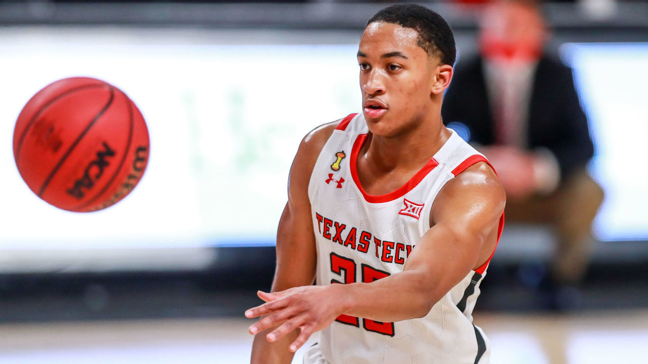 LUBBOCK, TEXAS - DECEMBER 29: Guard Nimari Burnett #25 of the Texas Tech Red Raiders passes the ball during the second half of the college basketball game against the Incarnate Word Cardinals at United Supermarkets Arena on December 29, 2020 in Lubbock, Texas.