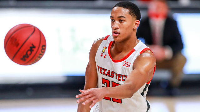LUBBOCK, TEXAS - DECEMBER 29: Guard Nimari Burnett #25 of the Texas Tech Red Raiders passes the ball during the second half of the college basketball game against the Incarnate Word Cardinals at United Supermarkets Arena on December 29, 2020 in Lubbock, Texas.