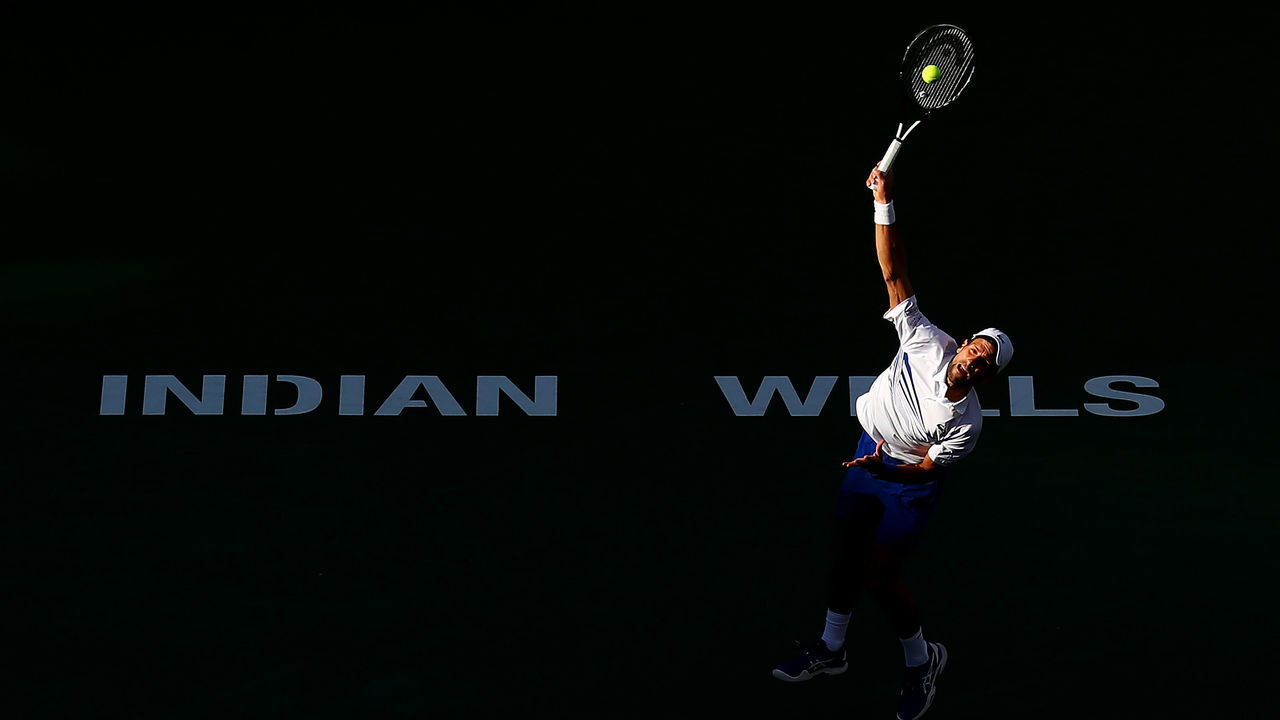 INDIAN WELLS, CALIFORNIA - MARCH 15: Novak Djokovic of Serbia serves while playing with Fabio Fognini of Italy against Lukasz Kubot of Poland and Marcelo Melo of Brazil during their men's doubles semifinal match on Day 12 of the BNP Paribas Open at the Indian Wells Tennis Garden on March 15, 2019 in Indian Wells, California.