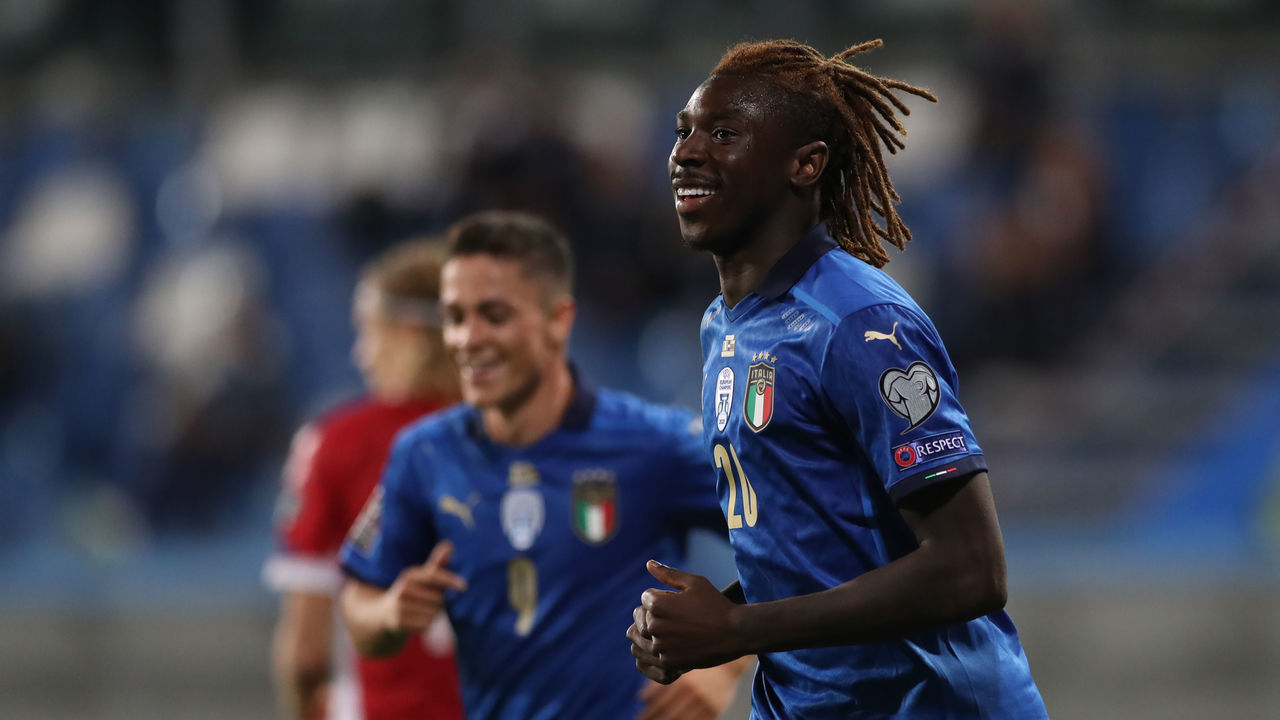 REGGIO NELL'EMILIA, ITALY - SEPTEMBER 08: Moise Kean of Italy smiles after team mate Giovanni Di Lorenzo scored to give the side a 5-0 lead during the 2022 FIFA World Cup Qualifier match between Italy and Lithuania at Mapei Stadium - Citta' del Tricolore on September 08, 2021 in Reggio nell'Emilia, .