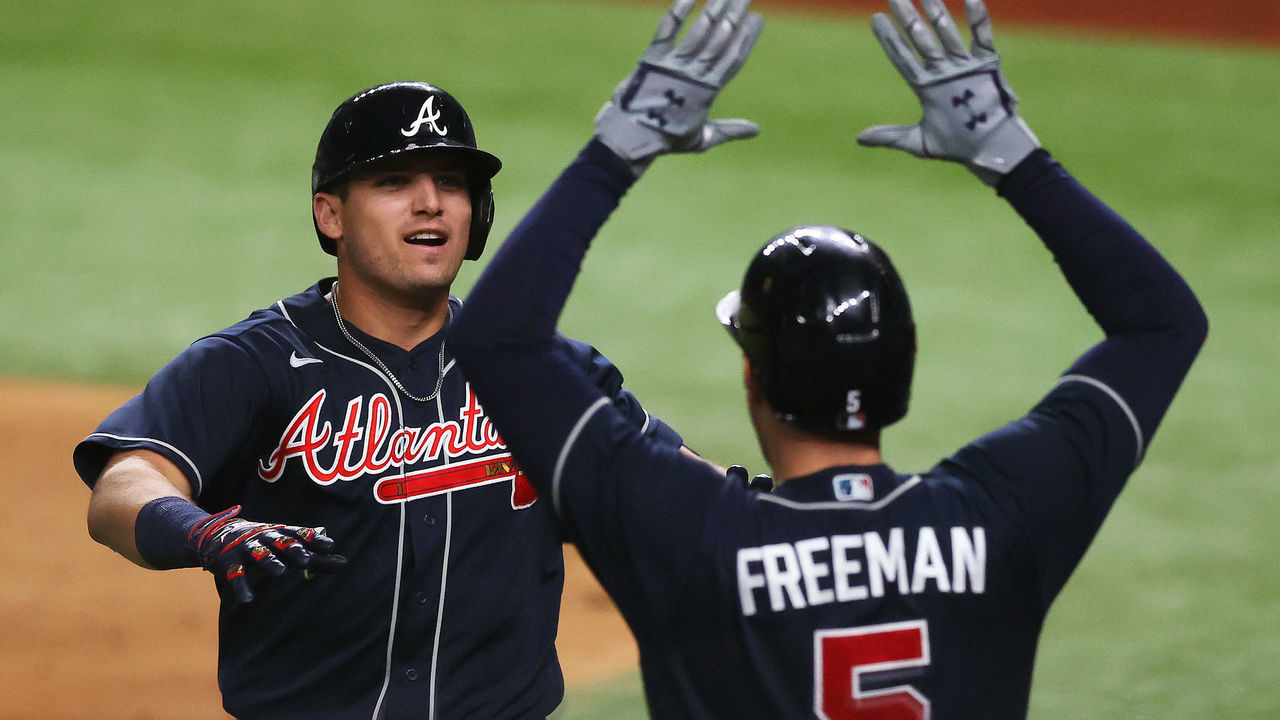 ARLINGTON, TEXAS - OCTOBER 12: Austin Riley #27 of the Atlanta Braves celebrates a solo home run with teammate Freddie Freeman #5 against the Los Angeles Dodgers during the ninth inning in Game One of the National League Championship Series at Globe Life Field on October 12, 2020 in Arlington, Texas.