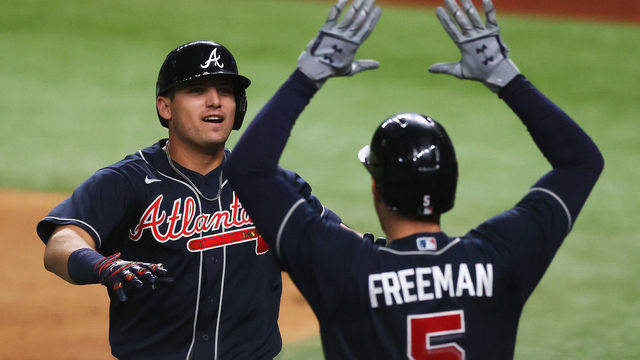 ARLINGTON, TEXAS - OCTOBER 12: Austin Riley #27 of the Atlanta Braves celebrates a solo home run with teammate Freddie Freeman #5 against the Los Angeles Dodgers during the ninth inning in Game One of the National League Championship Series at Globe Life Field on October 12, 2020 in Arlington, Texas.