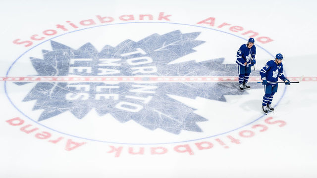 TORONTO, ON - MAY 8: Mitchell Marner #16 of the Toronto Maple Leafs and Auston Matthews #34 skate over the logo at centre ice at an NHL game against the Montreal Canadiens during the second period at the Scotiabank Arena on May 8, 2021 in Toronto, Ontario, Canada.