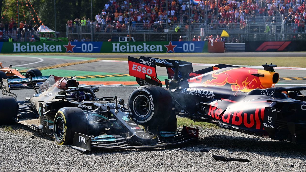 Mercedes' British driver Lewis Hamilton (L) reacts in his car following a collision with Red Bull's Dutch driver Max Verstappen (unseen) during the Italian Formula One Grand Prix at the Autodromo Nazionale circuit in Monza, on September 12, 2021.
