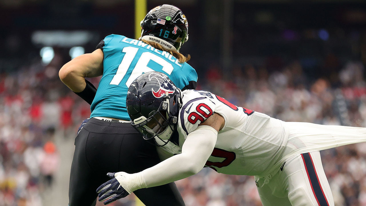 HOUSTON, TEXAS - SEPTEMBER 12: Ross Blacklock #90 of the Houston Texans tackles Trevor Lawrence #16 of the Jacksonville Jaguars during the second quarter at NRG Stadium on September 12, 2021 in Houston, Texas.