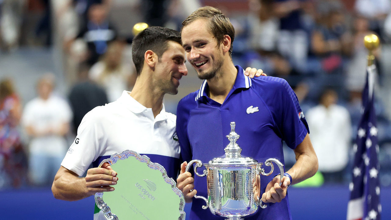 NEW YORK, NEW YORK - SEPTEMBER 12: Novak Djokovic of Serbia holds the runner-up trophy and talks with Daniil Medvedev of Russia who celebrates with the championship trophy after winning their Men's Singles final match on Day Fourteen of the 2021 US Open at the USTA Billie Jean King National Tennis Center on September 12, 2021 in the Flushing neighborhood of the Queens borough of New York City.