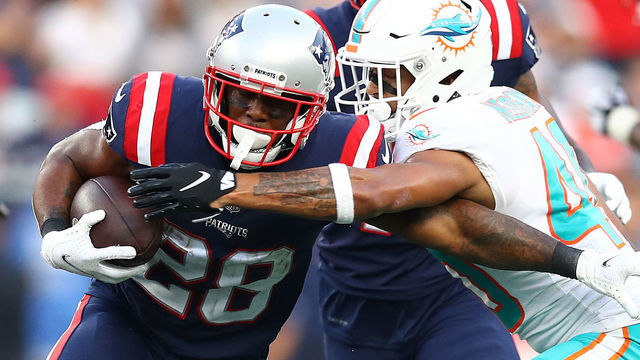 FOXBOROUGH, MASSACHUSETTS - SEPTEMBER 12: James White #28 of the New England Patriots runs with the ball against Nik Needham #40 of the Miami Dolphins during the second half at Gillette Stadium on September 12, 2021 in Foxborough, Massachusetts.