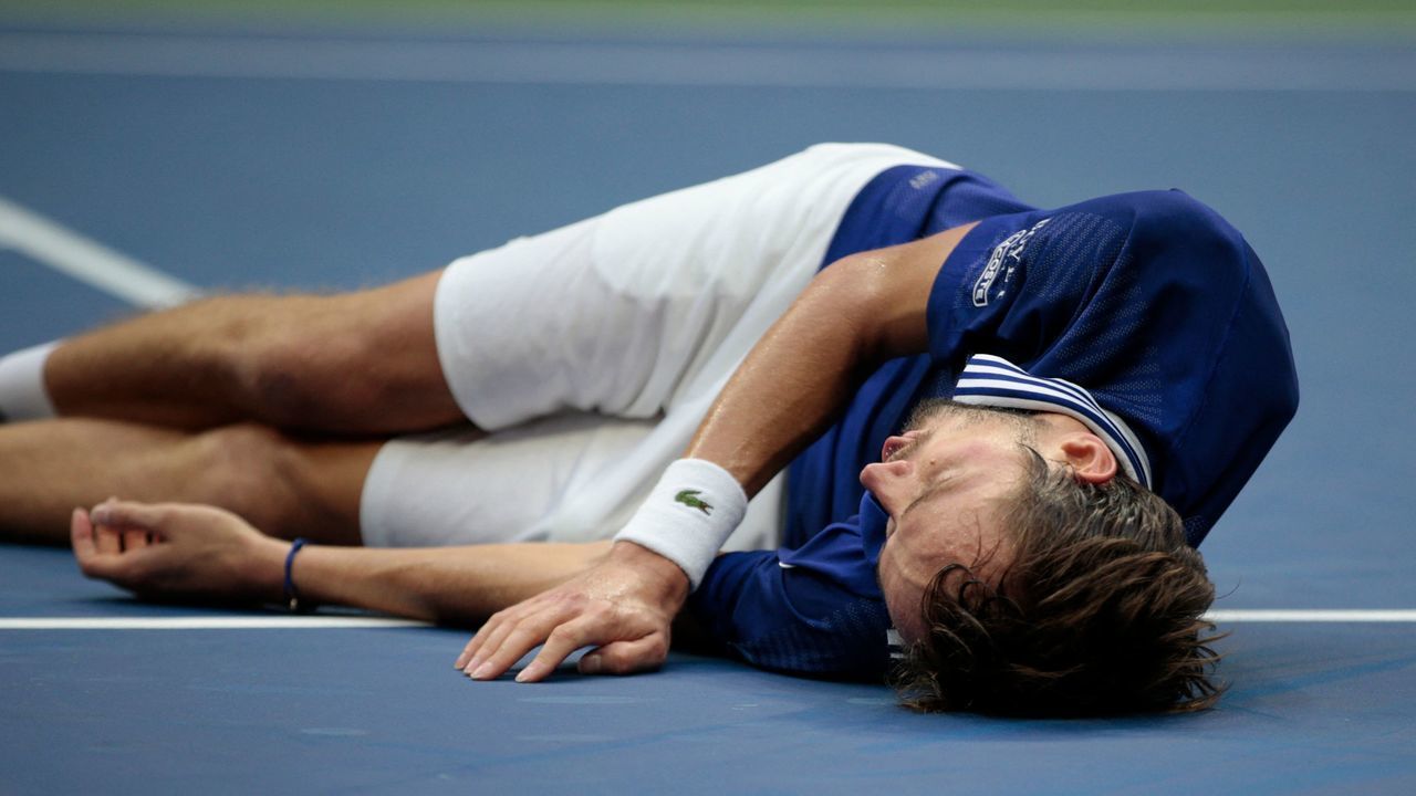 Russia's Daniil Medvedev drops to the ground in celebration of his win over Serbia's Novak Djokovic during their 2021 US Open Tennis tournament men's final match at the USTA Billie Jean King National Tennis Center in New York, on September 12, 2021.