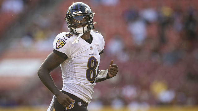 LANDOVER, MD - AUGUST 28: Lamar Jackson #8 of the Baltimore Ravens looks on against the Washington Football Team during the first half of the preseason game at FedExField on August 28, 2021 in Landover, Maryland.