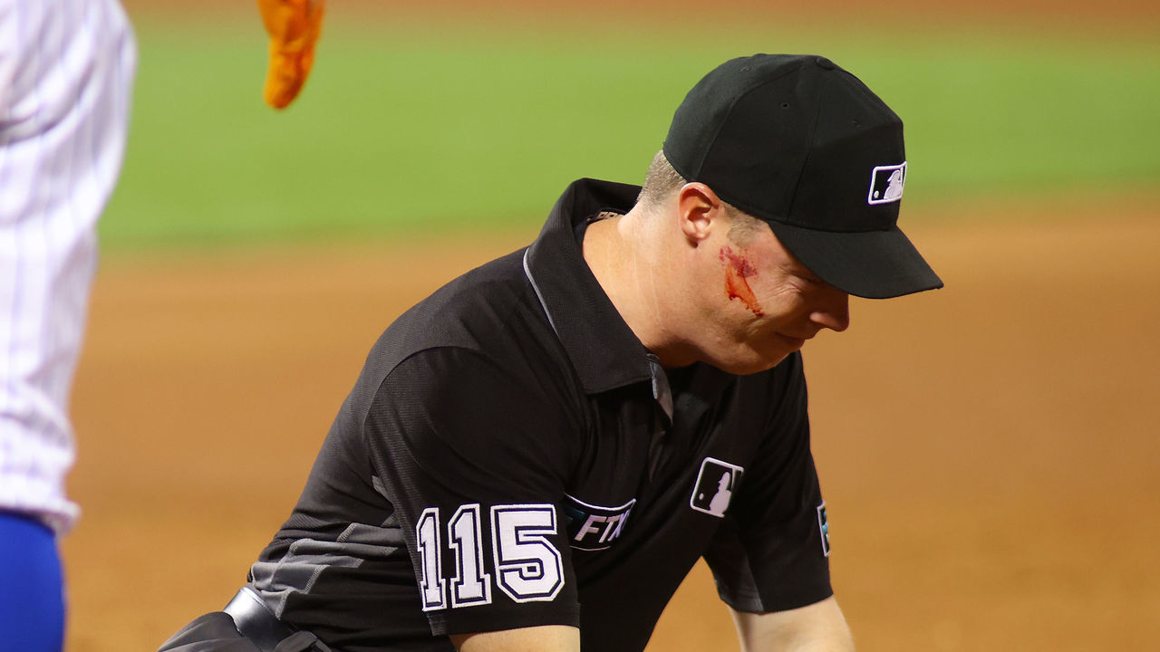 NEW YORK, NEW YORK - SEPTEMBER 13: Umpire Junior Valentine reacts after getting hit in the face with the ball on a throw from Edmundo Sosa #63 of the St. Louis Cardinals in the second inning against the New York Mets at Citi Field on September 13, 2021 in New York City.