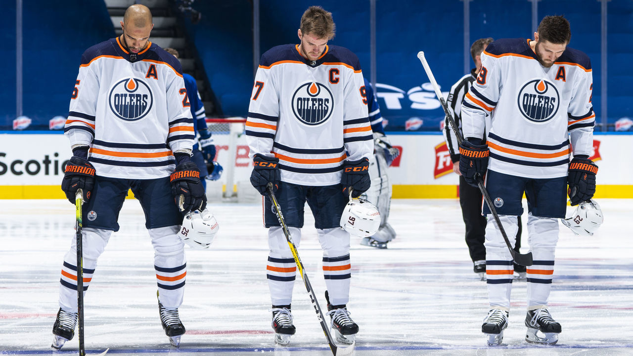 TORONTO, ON - MARCH 27: Connor McDavid #97, Darnell Nurse #25, and Leon Draisaitl #29 of the Edmonton Oilers stand on the ice during the national anthem before playing the Toronto Maple Leafs at the Scotiabank Arena on March 27, 2021 in Toronto, Ontario, Canada.