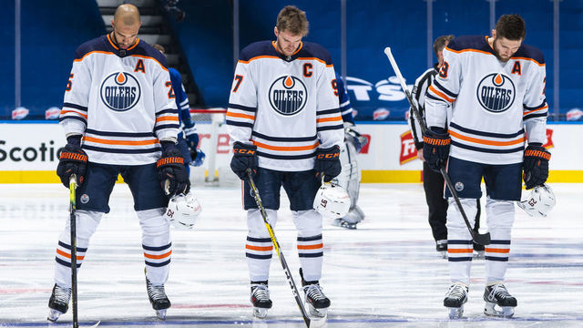 TORONTO, ON - MARCH 27: Connor McDavid #97, Darnell Nurse #25, and Leon Draisaitl #29 of the Edmonton Oilers stand on the ice during the national anthem before playing the Toronto Maple Leafs at the Scotiabank Arena on March 27, 2021 in Toronto, Ontario, Canada.