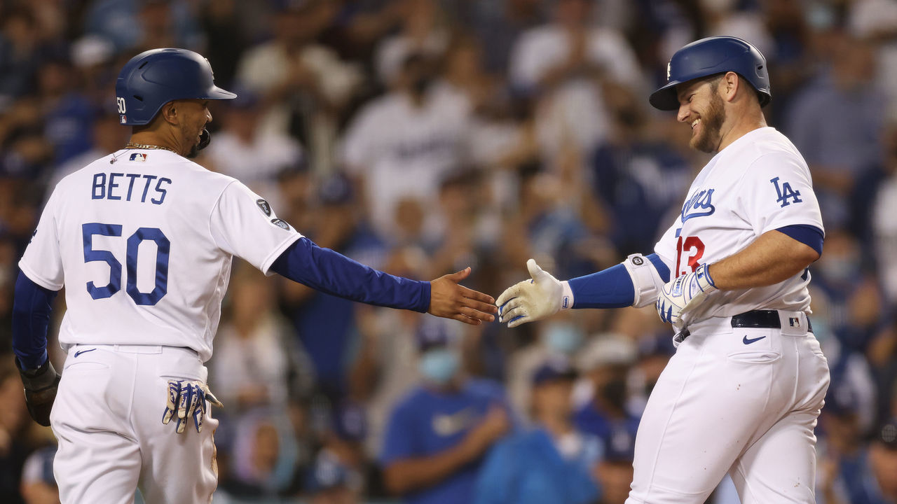 LOS ANGELES, CALIFORNIA - SEPTEMBER 14: Max Muncy #13 of the Los Angeles Dodgers celebrates his two run homerun with Mookie Betts #50, to take a 3-0 lead over the Arizona Diamondbacks, during the third inning at Dodger Stadium on September 14, 2021 in Los Angeles, California.