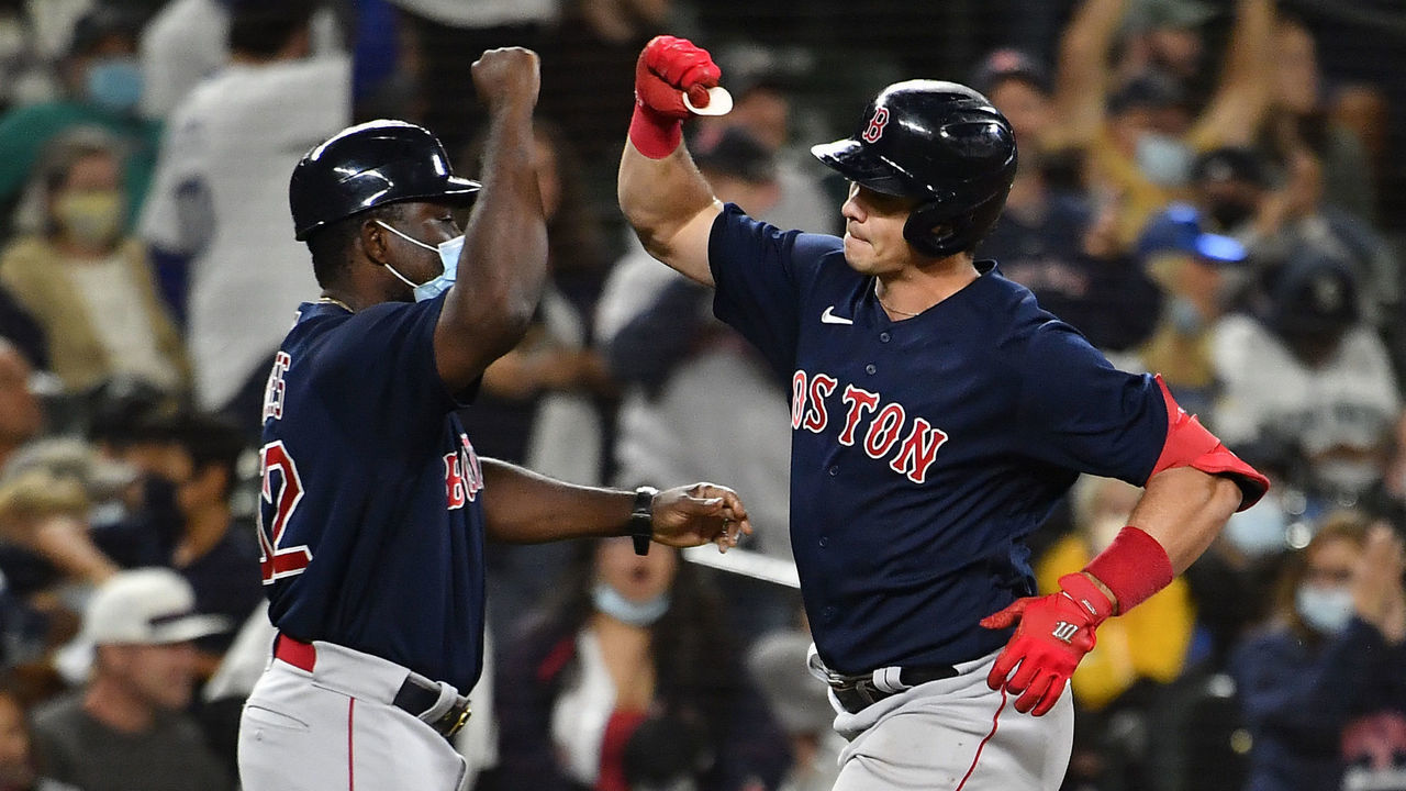 SEATTLE, WASHINGTON - SEPTEMBER 14: Bobby Dalbec #29 of the Boston Red Sox celebrates with third base coach Carlos Febles #52 after hitting a home run during the sixth inning against the Seattle Mariners at T-Mobile Park on September 14, 2021 in Seattle, Washington.