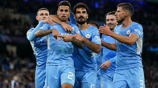 Manchester City's Joao Cancelo (second left) celebrates with Phil Foden (left), Ilkay Gundogan (centre) and Ruben Dias (right) after scoring their side's fifth goal of the game during the UEFA Champions League, Group A match at the Etihad Stadium, Manchester. Picture date: Wednesday September 15, 2021.