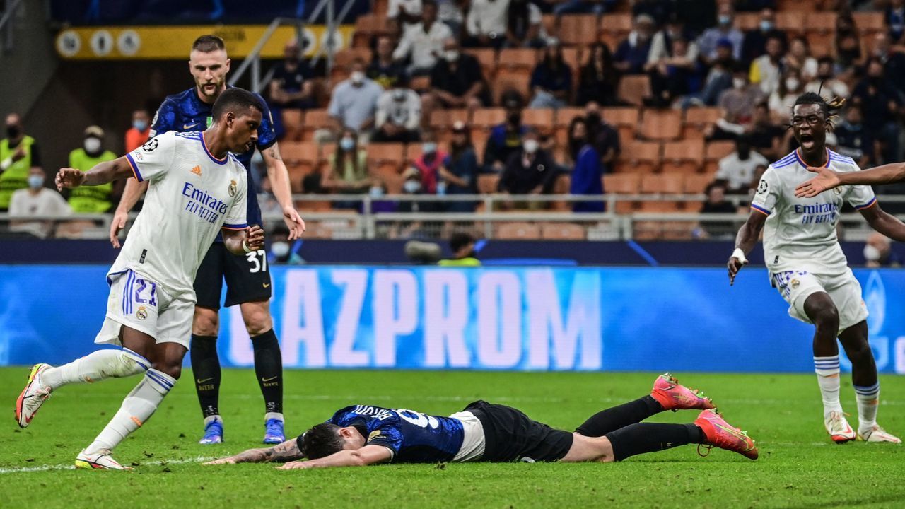 Real Madrid's Brazilian forward Rodrygo (L) celebrates after opening the scoring during the UEFA Champions League Group D football match between Inter Milan and Real Madrid on September 15, 2021 at the San Siro stadium in Milan.