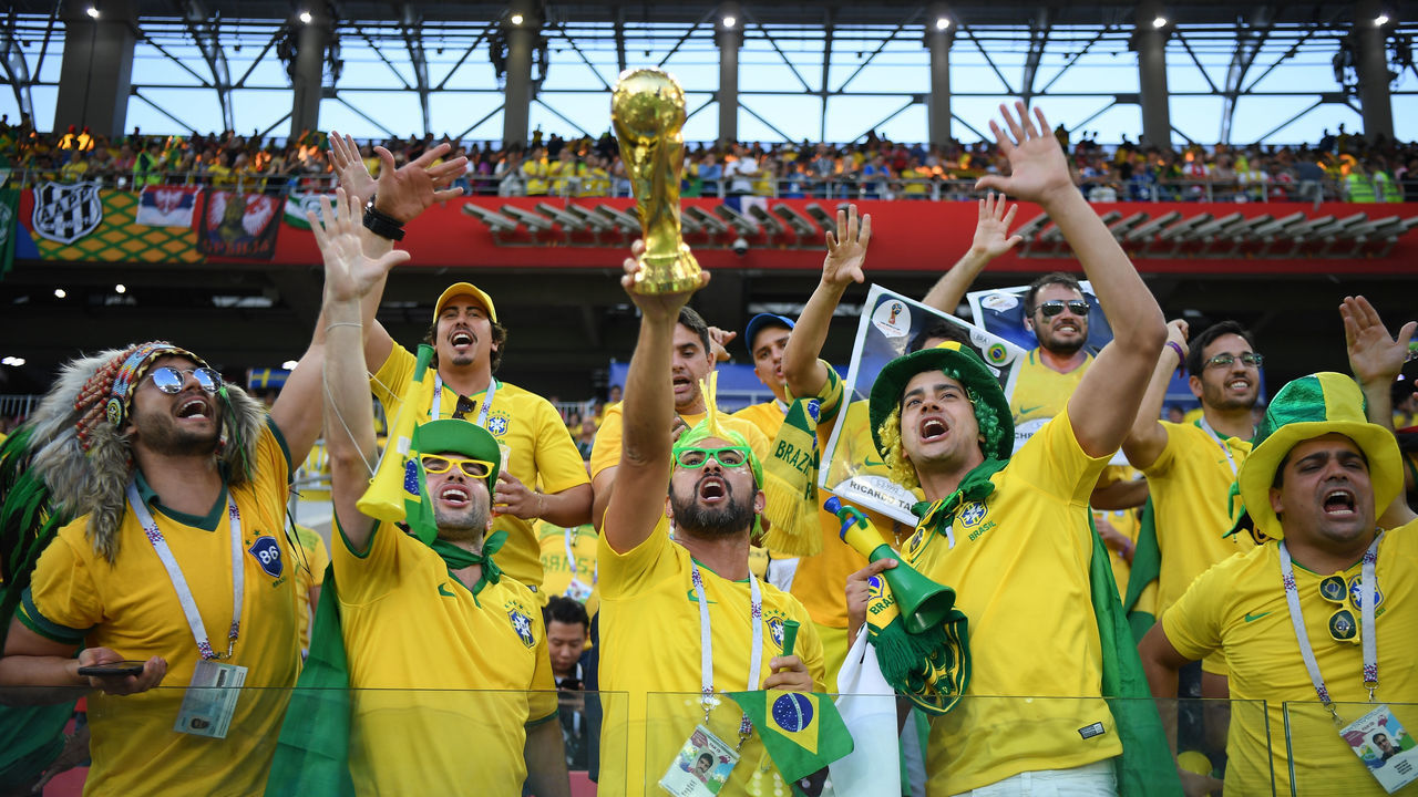 MOSCOW, RUSSIA - JUNE 27: Fans of Brazil hold their replica World Cup trophys during the 2018 FIFA World Cup Russia group E match between Serbia and Brazil at Spartak Stadium on June 27, 2018 in Moscow, Russia.