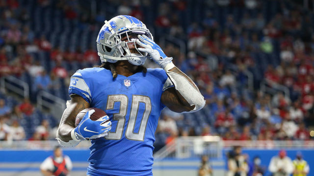DETROIT, MI - SEPTEMBER 12: Detroit Lions running back Jamaal Williams (30) blows a kiss to the fans after running into the end zone for a touchdown during the fourth quarter of a regular season NFL game between the San Francisco 49ers and the Detroit Lions on September 12, 2021 at Ford Field in Detroit, Michigan.