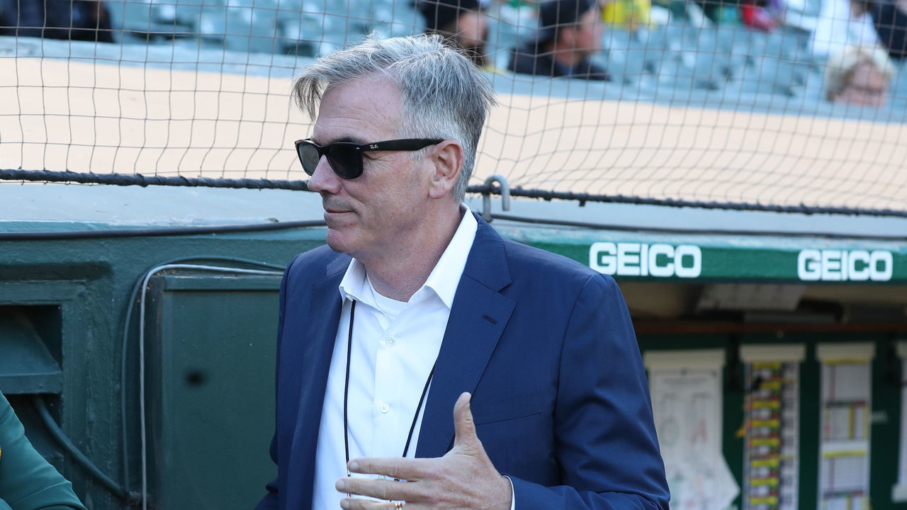 OAKLAND, CA - JUNE 08: Third Base Coach Mark Kotsay #7 and Executive Vice President of Baseball Operations Billy Beane of the Oakland Athletics talk in the dugout before the game against the Arizona Diamondbacks at RingCentral Coliseum on June 8, 2021 in Oakland, California. The Athletics defeated the Diamondbacks 5-2.