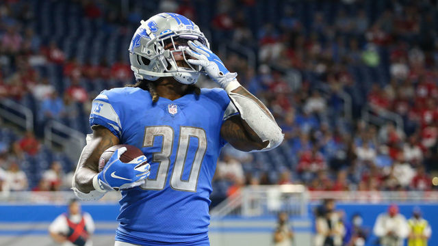 DETROIT, MI - SEPTEMBER 12: Detroit Lions running back Jamaal Williams (30) blows a kiss to the fans after running into the end zone for a touchdown during the fourth quarter of a regular season NFL game between the San Francisco 49ers and the Detroit Lions on September 12, 2021 at Ford Field in Detroit, Michigan.