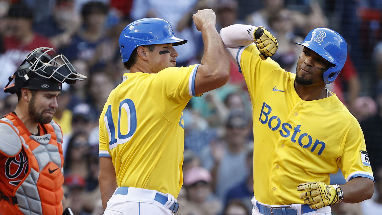 BOSTON, MA - SEPTEMBER 18: Catcher Austin Wynns #61 of the Baltimore Orioles looks down as Xander Bogaerts #2 of the Boston Red Sox is congratulated by teammate Hunter Renfroe #10 after Bogaerts' three-run home run during the sixth inning at Fenway Park on September 18, 2021 in Boston, Massachusetts.
