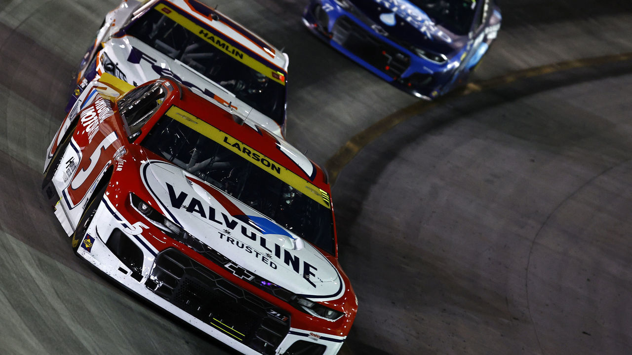 BRISTOL, TENNESSEE - SEPTEMBER 18: Kyle Larson, driver of the #5 Valvoline Chevrolet, leads Denny Hamlin, driver of the #11 FedEx Freight Toyota, during the NASCAR Cup Series Bass Pro Shops Night Race at Bristol Motor Speedway on September 18, 2021 in Bristol, Tennessee.