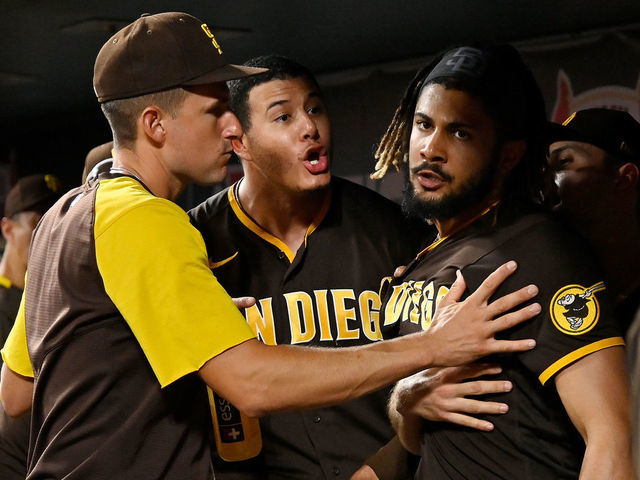 ST LOUIS, MO - SEPTEMBER 18: Manny Machado #13 and Fernando Tatis Jr. #23 of the San Diego Padres exchange words in the dugout during the fifth inning against the St. Louis Cardinals at Busch Stadium on September 18, 2021 in St Louis, Missouri.