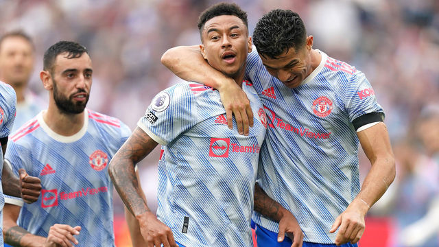 Manchester United's Jesse Lingard (centre) celebrates scoring their side's second goal of the game with Cristiano Ronaldo (right) during the Premier League match at the London Stadium, London. Picture date: Sunday September 19, 2021.