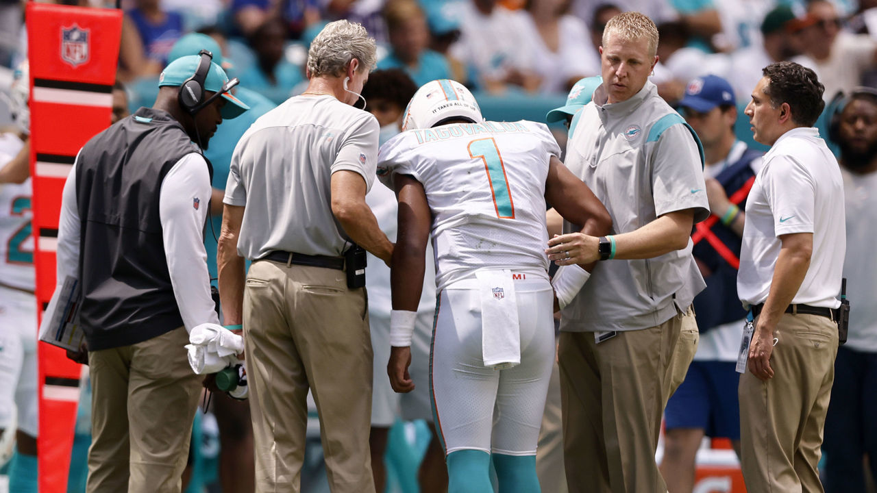 MIAMI GARDENS, FLORIDA - SEPTEMBER 19: Quarterback Tua Tagovailoa #1 of the Miami Dolphins is helped off the field in the first half of the game against the Buffalo Bills at Hard Rock Stadium on September 19, 2021 in Miami Gardens, Florida.