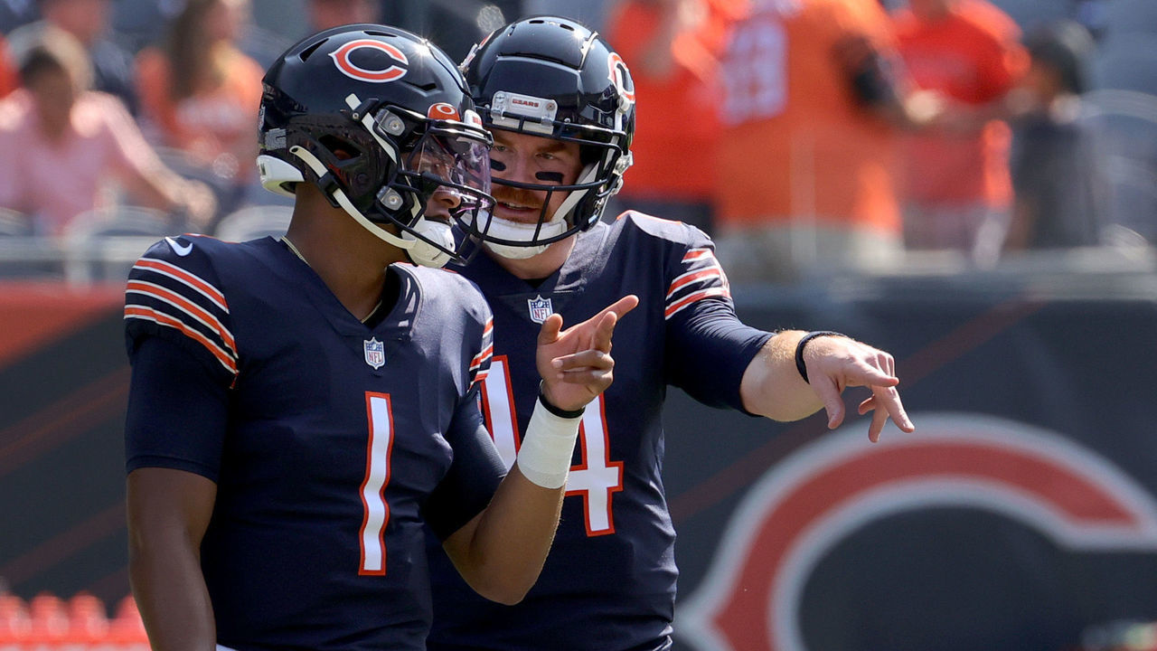 CHICAGO, ILLINOIS - SEPTEMBER 19: (L-R) Quarterback Justin Fields #1 talks with Quarterback Andy Dalton #14 of the Chicago Bears talks before the game against the Cincinnati Bengals at Soldier Field on September 19, 2021 in Chicago, Illinois.