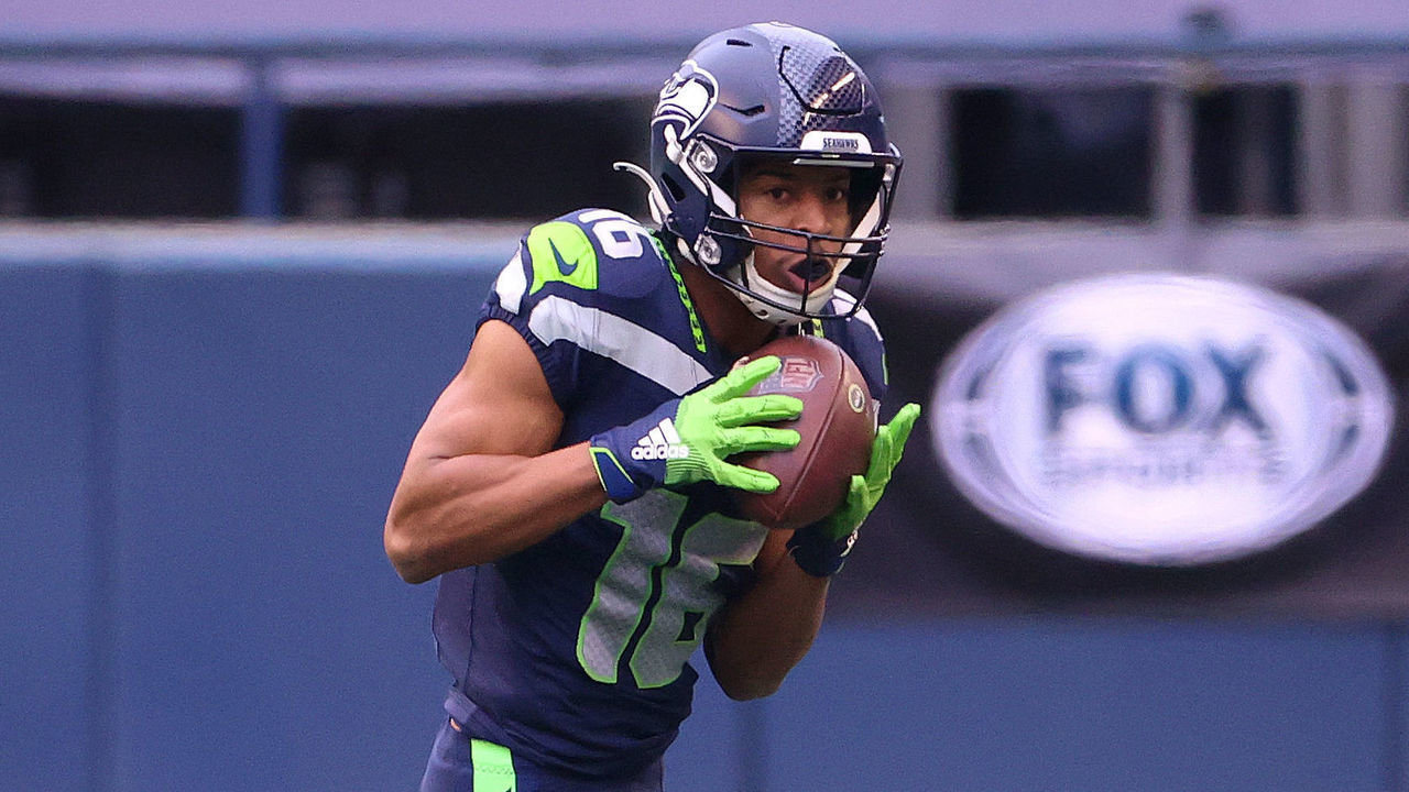 SEATTLE, WASHINGTON - JANUARY 09: Tyler Lockett #16 of the Seattle Seahawks runs with the ball in the second quarter against the Los Angeles Rams during the NFC Wild Card Playoff game at Lumen Field on January 09, 2021 in Seattle, Washington.