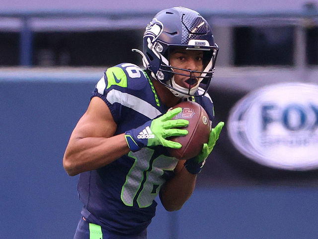SEATTLE, WASHINGTON - JANUARY 09: Tyler Lockett #16 of the Seattle Seahawks runs with the ball in the second quarter against the Los Angeles Rams during the NFC Wild Card Playoff game at Lumen Field on January 09, 2021 in Seattle, Washington.