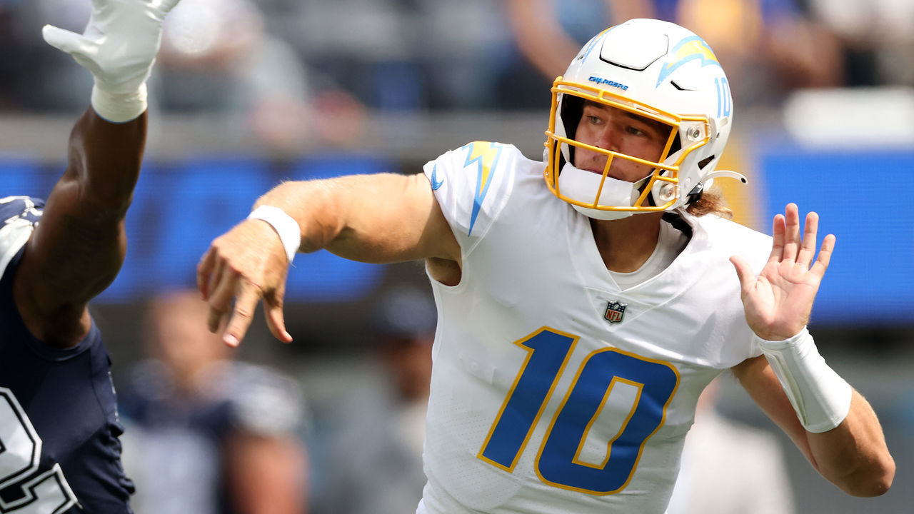 INGLEWOOD, CALIFORNIA - SEPTEMBER 19: Quarterback Justin Herbert (10) of the Los Angeles Chargers throws a first quarter interception as he's pressured by defensive end Dorance Armstrong (92) of the Dallas Cowboys at SoFi Stadium on September 19, 2021 in Inglewood, California.