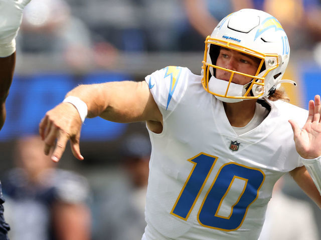 INGLEWOOD, CALIFORNIA - SEPTEMBER 19: Quarterback Justin Herbert (10) of the Los Angeles Chargers throws a first quarter interception as he's pressured by defensive end Dorance Armstrong (92) of the Dallas Cowboys at SoFi Stadium on September 19, 2021 in Inglewood, California.