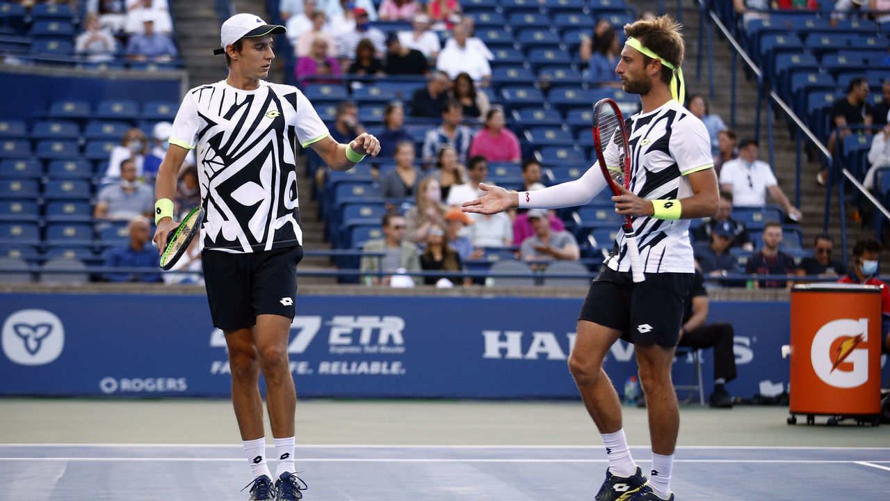 TORONTO, ON - AUGUST 14: Joran Vliegen (L) of Belgium high fives with partner Sander Gille of Belgium during a semifinal doubles match against Rajeev Ram of the United States and Joe Salisbury of Great Britain on Day Six of the National Bank Open at Aviva Centre on August 14, 2021 in Toronto, Ontario, Canada.