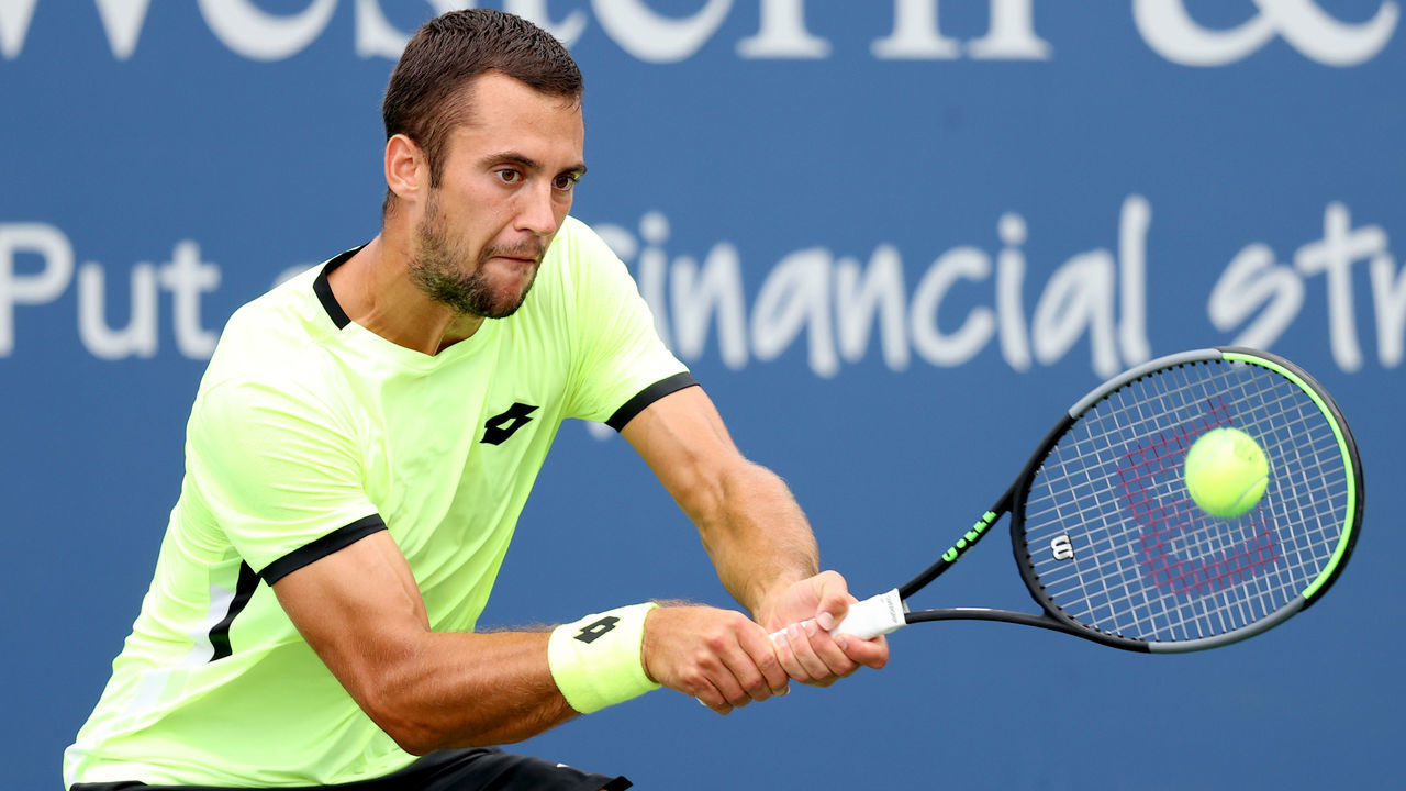 MASON, OHIO - AUGUST 17: Laslo Djere of Serbia returns a shot to Sebastian Korda during the Western & Southern Open at Lindner Family Tennis Center on August 17, 2021 in Mason, Ohio.