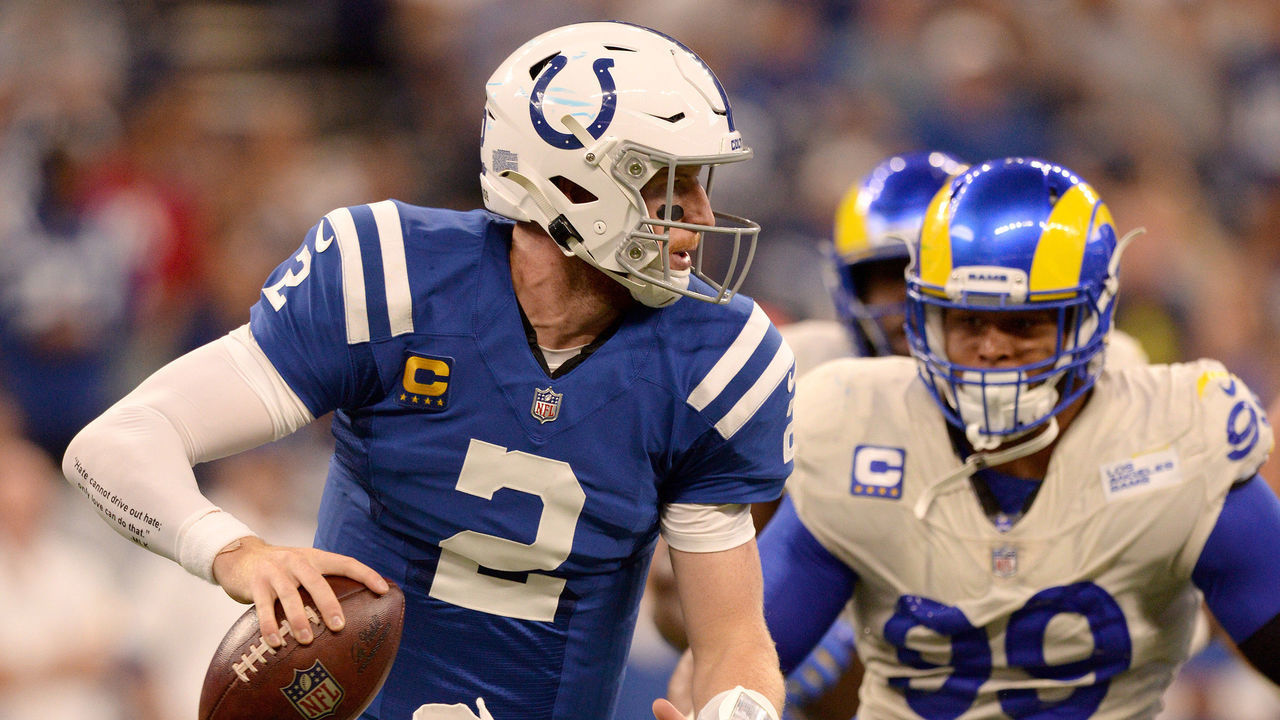 INDIANAPOLIS, IN - SEPTEMBER 19: Los Angeles Rams Defensive Tackle Aaron Donald (99) pursues Indianapolis Colts Quarterback Carson Wentz (2) during the NFL football game between the Los Angeles Rams and the Indianapolis Colts on September 19, 2021, at Lucas Oil Stadium in Indianapolis, Indiana.