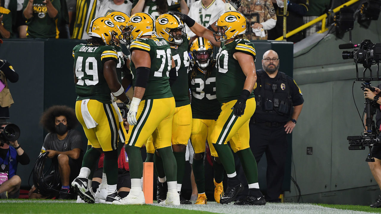 GREEN BAY, WISCONSIN - SEPTEMBER 20: Aaron Jones #33 of the Green Bay Packers celebrates a touchdown against the Detroit Lions with teammates during the first half at Lambeau Field on September 20, 2021 in Green Bay, Wisconsin.