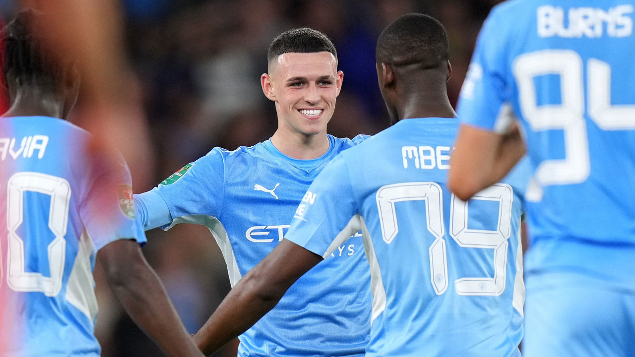 MANCHESTER, ENGLAND - SEPTEMBER 21: Phil Foden of Manchester City celebrates with Luke Mbete after scoring their side's third goal during the Carabao Cup Third Round match between Manchester City and Wycombe Wanderers F.C. at Etihad Stadium on September 21, 2021 in Manchester, England.