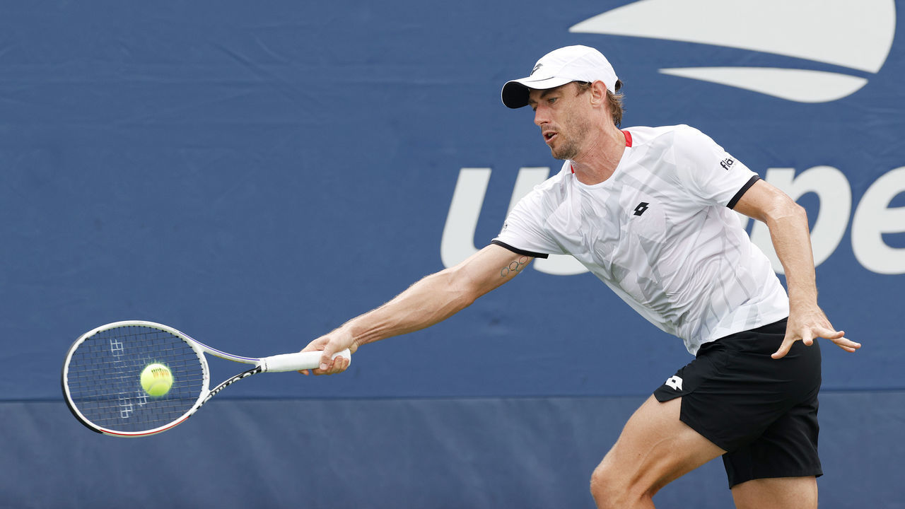 NEW YORK, NEW YORK - AUGUST 30: John Millman of Australia returns against Henri Laaksonen of Switzerland during their men's singles first round match on Day One of the 2021 US Open at the Billie Jean King National Tennis Center on August 30, 2021 in the Flushing neighborhood of the Queens borough of New York City.