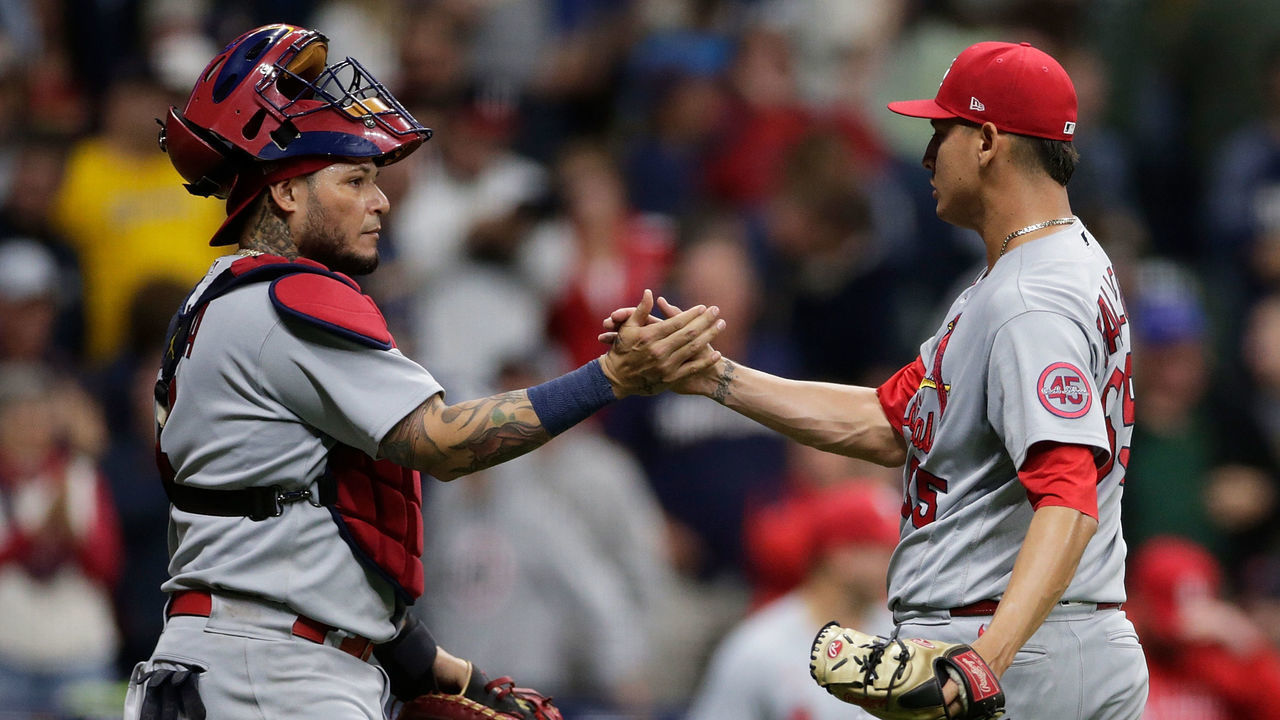 MILWAUKEE, WISCONSIN - SEPTEMBER 21: Yadier Molina #4 and Giovanny Gallegos #65 of the St. Louis Cardinals shake hands after the final out of the game at American Family Field on September 21, 2021 in Milwaukee, Wisconsin.