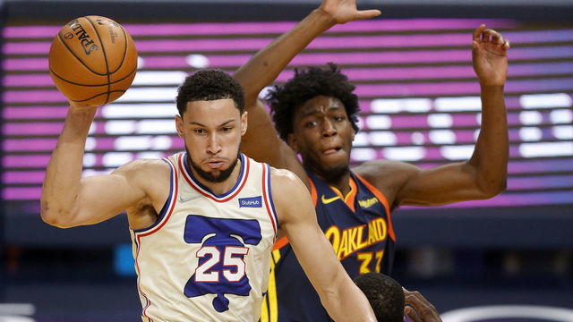 SAN FRANCISCO, CALIFORNIA - MARCH 23: Ben Simmons #25 of the Philadelphia 76ers passes the ball while guarded by James Wiseman #33 of the Golden State Warriors at Chase Center on March 23, 2021 in San Francisco, California.