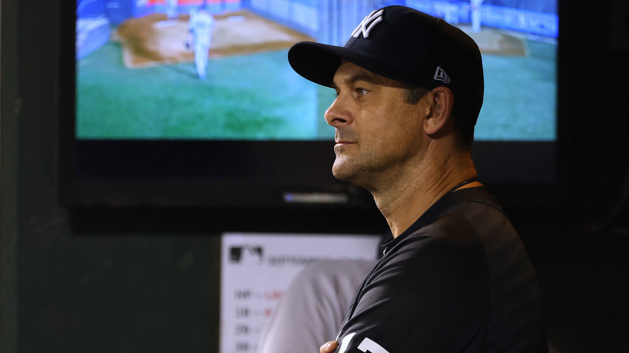 NEW YORK, NY - SEPTEMBER 12: Manager Aaron Boone #17 of the New York Yankees in action against the New York Mets during a game at Citi Field on September 12, 2021 in New York City.