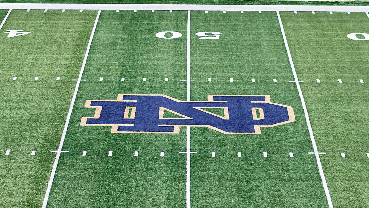 SOUTH BEND, IN - SEPTEMBER 01: A detailed view of a Notre Dame Fighting Irish logo is seen at the fifty yard line marker on the Notre Dame Stadium field prior to game action during the college football game between the Michigan Wolverines and the Notre Dame Fighting Irish on September 1, 2018 at Notre Dame Stadium, in South Bend, Indiana. The Notre Dame Fighting Irish defeated the Michigan Wolverines by the score of 24-17.