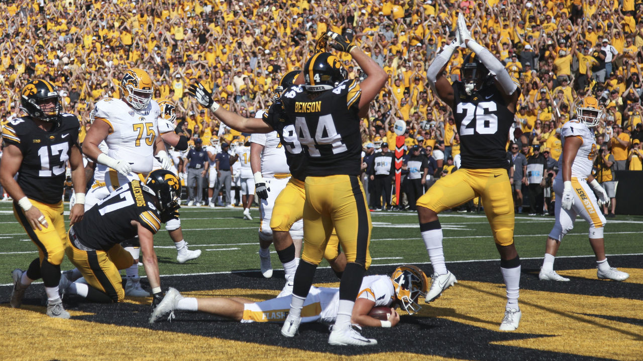 IOWA CITY, IOWA- SEPTEMBER 18: Defensive back Kaevon Merriweather #26 of the Iowa Hawkeyes signals a safety while celebrating with linebacker Seth Benson #44 during the first half over top quarterback Dustin Crum #7of the Kent State Golden Flashes at Kinnick Stadium on September 18, 2021 in Iowa City, Iowa.
