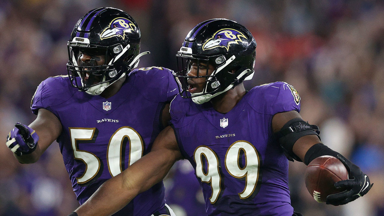BALTIMORE, MARYLAND - SEPTEMBER 19: Odafe Oweh #99 of the Baltimore Ravens celebrates with Justin Houston #50 after forcing and recovering a fumble against the Kansas City Chiefs during the fourth quarter at M&T Bank Stadium on September 19, 2021 in Baltimore, Maryland.