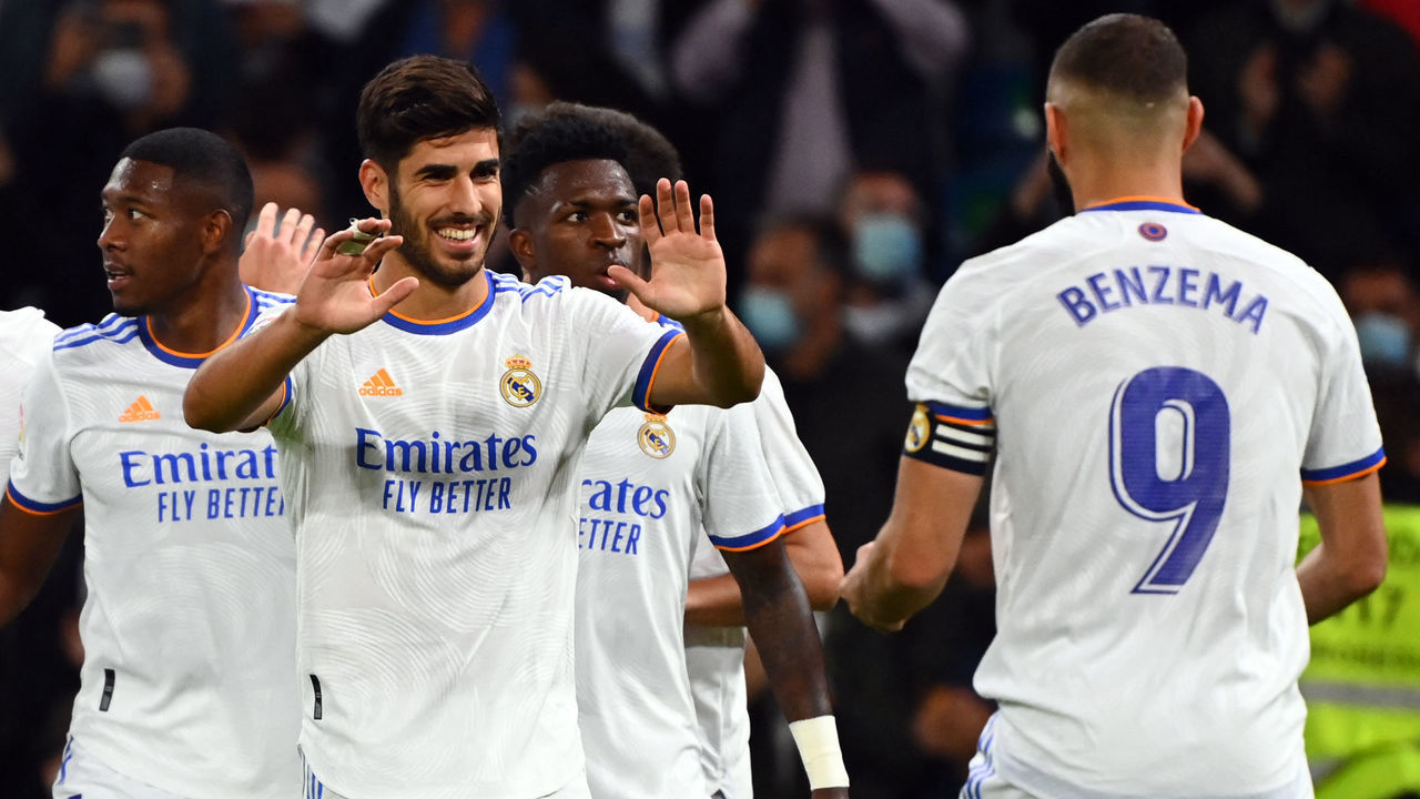 Real Madrid's Spanish midfielder Marco Asensio (2L) celebrates scoring his team's fourth goal during the Spanish League footbal match between Real Madrid CF and Real Mallorca at the Santiago Bernabeu stadium in Madrid on September 22, 2021.